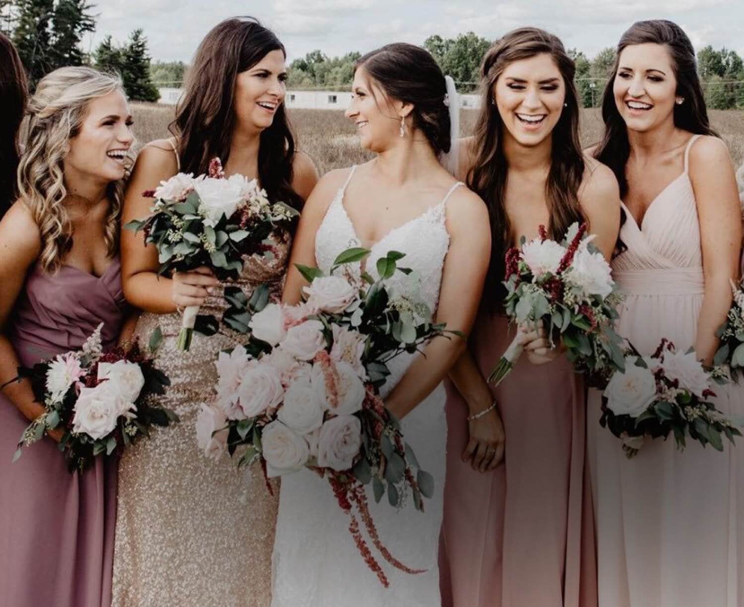 Bridesmaids wearing pink evening dresses