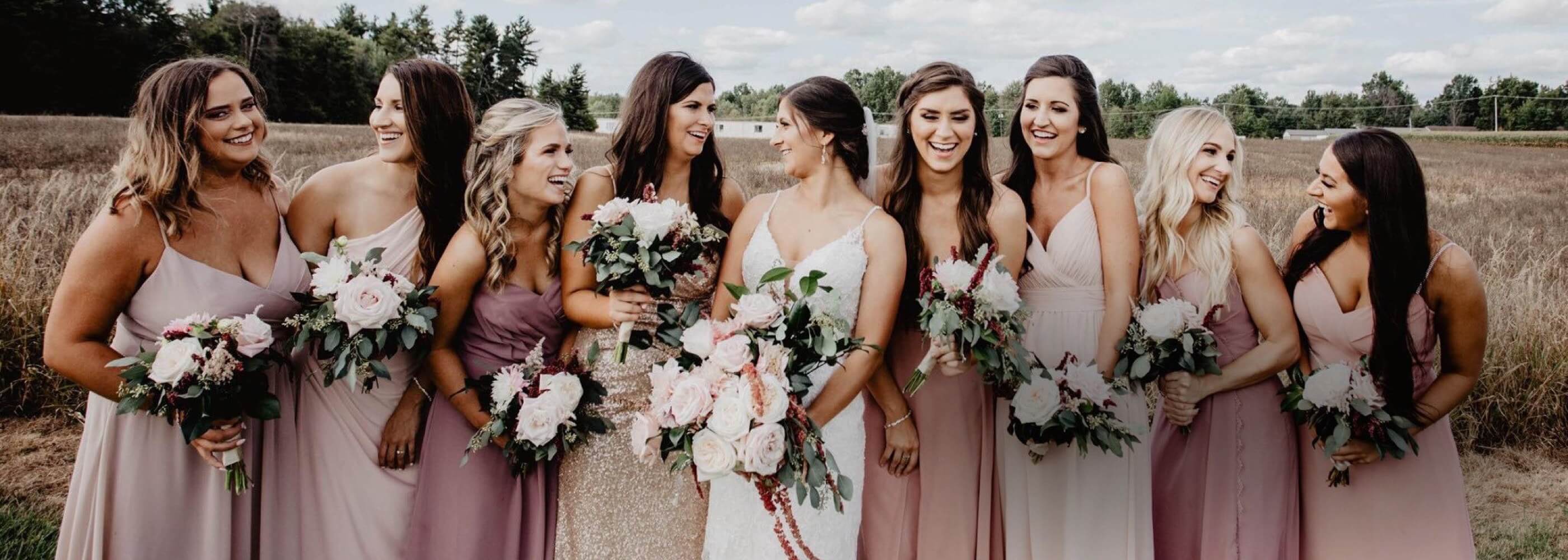 Bridesmaids wearing pink evening dresses