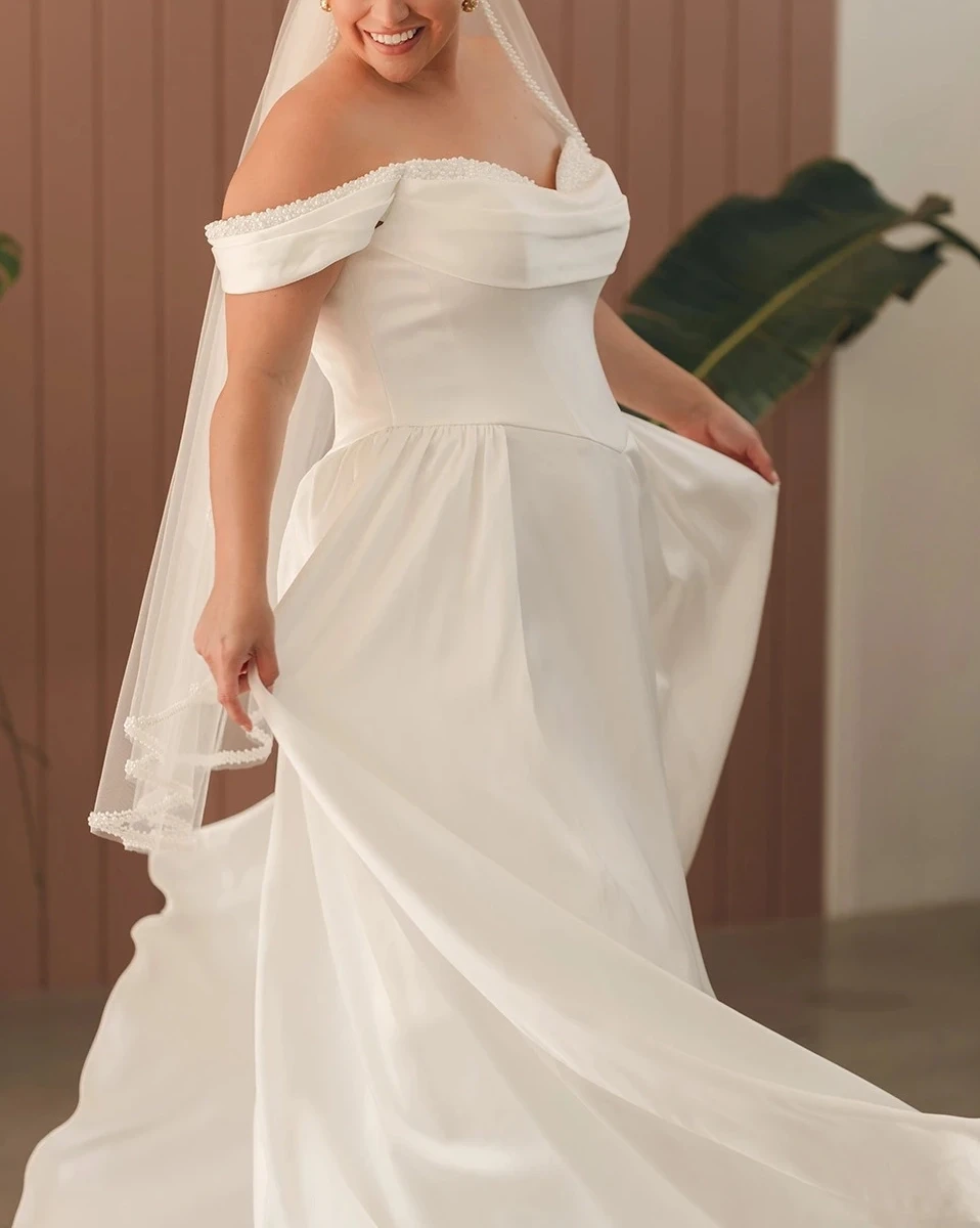 Plus size model wearing a white wedding dress